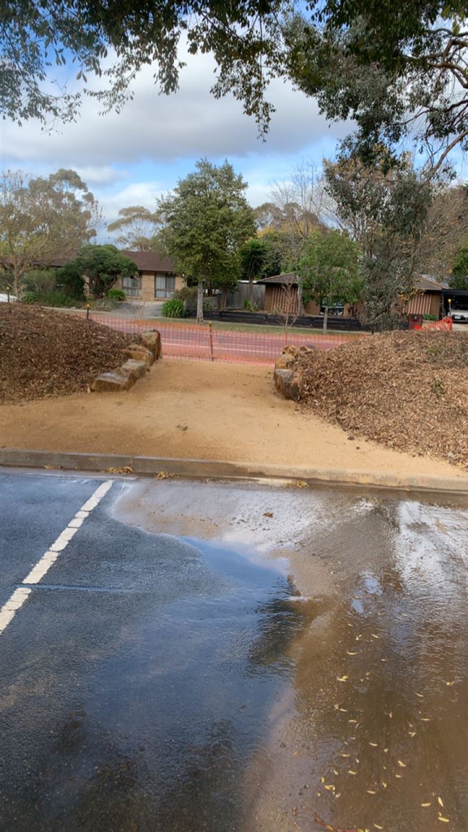 Civil pathway works with compacted gravel path and boulder edging, built by Sunnybank Horticultural